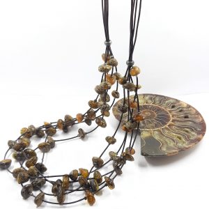 Žalios spalvos Baltijos gintaro karoliai ant odos